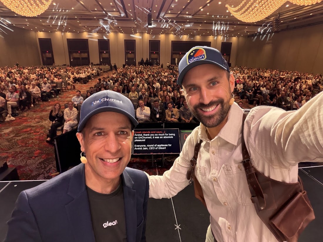 Josh and Arvind Jain taking a selfie on stage in front of a packed ballroom