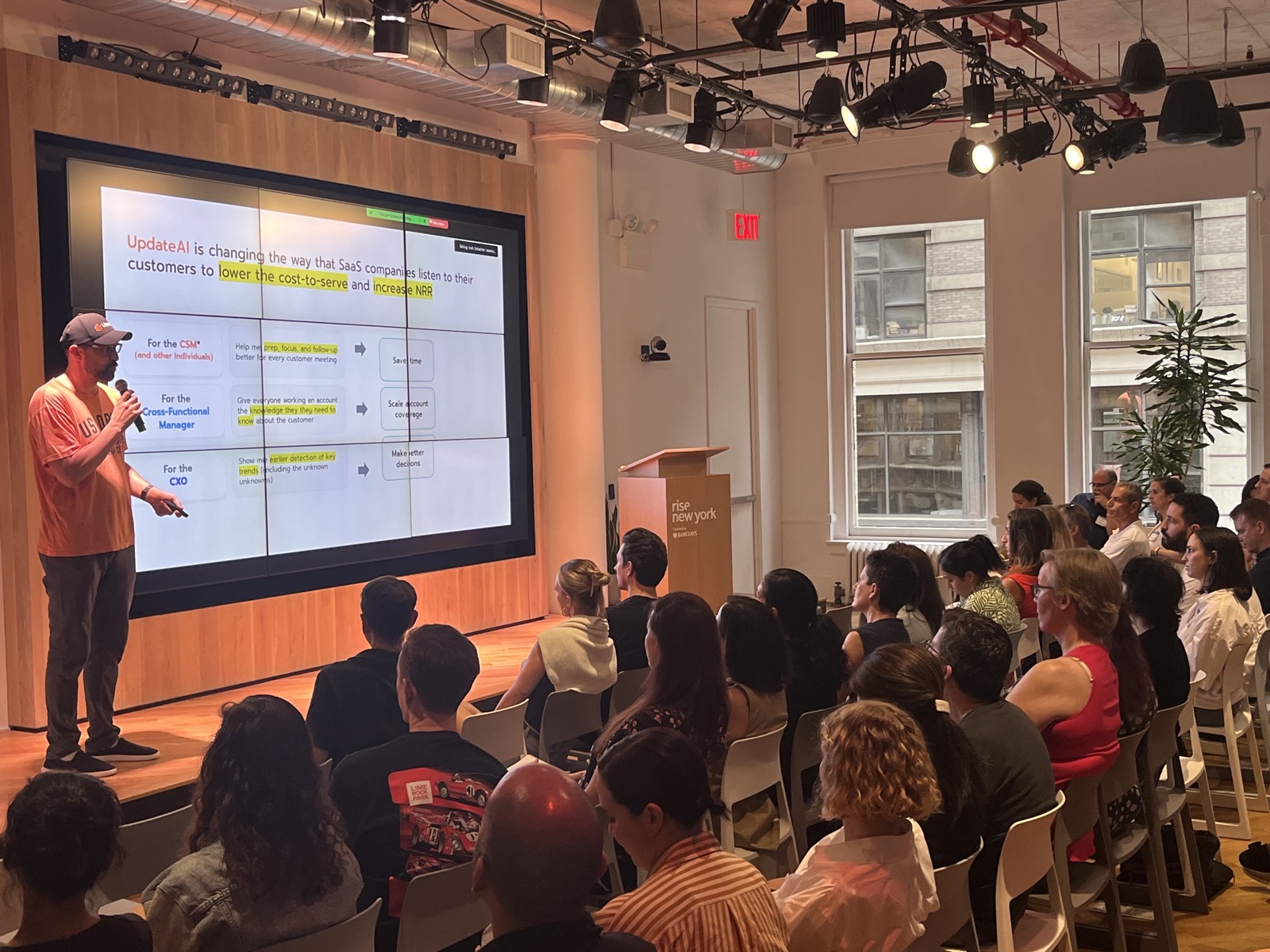 Josh presenting UpdateAI to a packed room at Rise New York